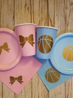 three paper cups with bows and basketballs on them