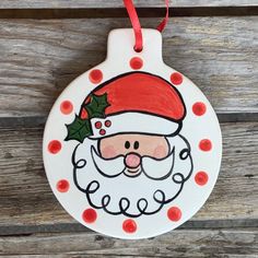 a ceramic ornament with a santa clause on it