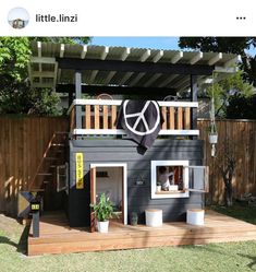 a dog house built into the side of a fenced in yard with stairs leading up to it