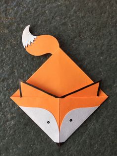 an origami fox is shown on the ground