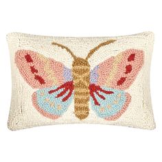 an embroidered butterfly pillow on a white background