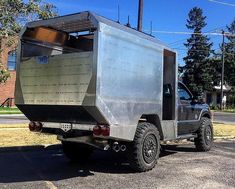 an off - road vehicle is parked in a parking lot with its back door open