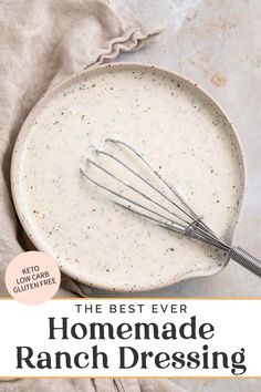 the best ever homemade ranch dressing in a white bowl with a whisk on top