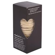 a box of cookies with a heart cut out of the top and inside, on a white background