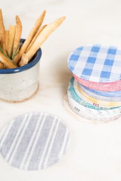 french fries and coasters sitting on a table next to a potted plant in a ceramic container