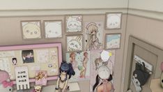 a room with many pictures and dolls on the wall