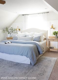 a large bed sitting under a window in a bedroom