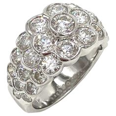 a white gold ring with diamonds on the top and bottom, set in 18k white gold