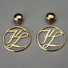 Features: - 100% Authentic KARL LAGERFELD. - Dangling earrings with open work KL logo medallion. - Gold tone. - Clipback earrings. - Signed KL at the back of one earring. - Excellent vintage condition. Measurements: Height: 3.07 inches (7.8 cm) Diameter: 2 inches (5.1 cm) Weight per Earring: 15 grams **These earrings will be shipped via Priority Shipping with tracking number. Please convo me for any queries and additional photos. Thank you for visiting. Other Fees that buyers need to know: Pleas Elegant Gold Earrings With Initials, Kl Logo, Vintage Karl Lagerfeld, Jeweled Earrings, One Earring, Christian Lacroix, Dangling Earrings, Pearl Stud Earrings, Rhinestone Earrings