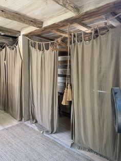 a room that has some curtains hanging from the ceiling and other items on the floor