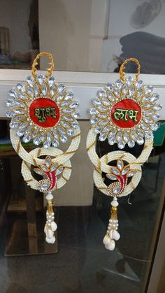 two pairs of earrings with beads hanging from them