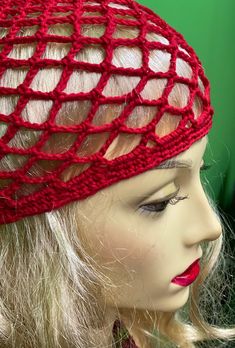 a mannequin head wearing a red netted hat