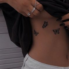 a woman with butterfly tattoos on her stomach