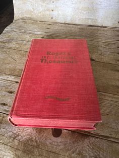 a red book sitting on top of a wooden table