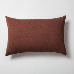 a brown pillow sitting on top of a white wall