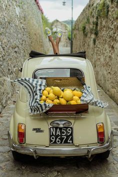 a car with a basket full of lemons in the back