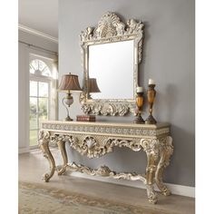 an ornate white console table with lamp and mirror