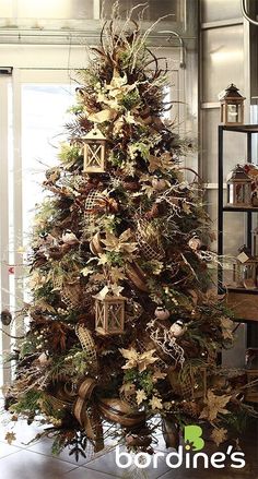 a decorated christmas tree in a living room with lots of decorations on top of it