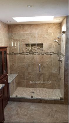 a walk in shower sitting inside of a bathroom