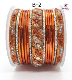 Product Description Gorgeous bangle set suitable for sarees and ethnic outfit. Stones into a shining form of jewelry is what we need to make you day. Lightweight, durable, & flawless finish with intricately crafted from metallic alloy. Actual color & quality of the image may slightly vary due to the lighting effects & screen resolution Dimension: 2.4", Refer to the size chart Select the style/design indicated on the bangle. Design: BGL#450 Orange Bangle For Festivals, Orange Festival Bangle Jewelry, Orange Jewelry For Diwali Puja, Traditional Festive Orange Bracelet, Bangle Design, Ethnic Outfits, Stud Set, Stone Studs, Bangle Set