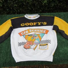 I Am Selling A Vintage 80 S Disney Goofy S Taxi Service Color Block Crewneck Sweatshirt. It Is Pre-Owned. The Sweatshirt Is Missing The Size Tag, Please Check All Of The Measurements Before Purchasing. I Believe It Is A Medium/Large. It Is Yellow And Black Color Block With White In The Center. On The Front Of The Sweatshirt It Has Goofy's Across It. Below That Is Goofy And It Has Cab Service And Rates On It. The Print Is Slightly Raised In A Puff Paint Style. The Collar Is White With A Black And White Pattern. The Collar Is Slightly Stretched Out, There Is A Loose Thread Which You Can See In The Pictures. On The Shoulder There Is A Loose Thread, Which You Can See In The Pictures. It Has A Di Yellow Casual Sweatshirt With Cartoon Print, Retro Long Sleeve Tops With Character Print, Yellow Long Sleeve Top With Character Print, Retro Yellow Sweatshirt For Streetwear, Yellow Crew Neck Top With Letter Print, Yellow Crew Neck Top With Graphic Print, Retro Cartoon Print Sweatshirt, Retro Yellow Tops With Logo Print, Yellow Sporty Sweatshirt With Graphic Print