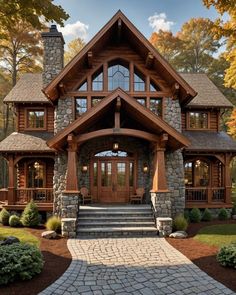 a large stone and wood house with steps leading up to the front door, surrounded by trees