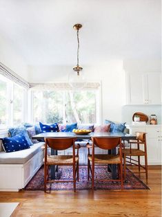 a living room with a couch, table and chairs