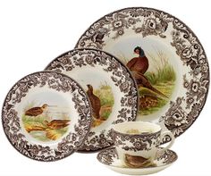 a set of four plates and cups with birds on them