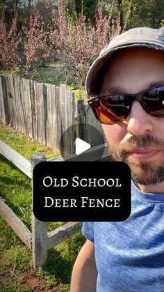 a man wearing sunglasses and a hat in front of a fence with the words old school deer fence