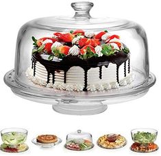 a cake under a glass dome with fruit toppings on the top and below it