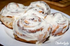 cinnamon rolls with icing on a white plate