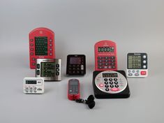 there are many different electronic devices on the table, including two phones and one calculator