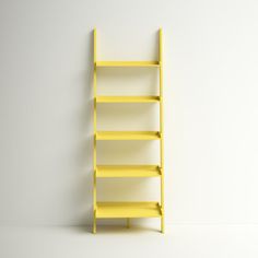 a yellow book shelf against a white wall