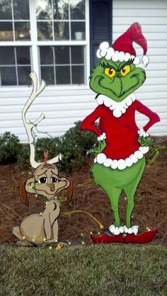 the grinch and reindeer are standing in front of a house