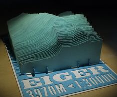 a paper sculpture made to look like an ocean wave with the words edger on it