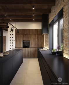 a modern kitchen with black counter tops and wooden cabinets, along with an island in the middle