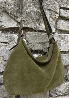 Handmade olive green suede hobo bag The bag is closed with a metallic zip. Inside is unlined and there is a large cotton zipped pocket. There is a adjustable shoulder strap made with strong hand dyed leather. This medium size hobo bag is a perfect bag for every moment Features : - olive green suede, - green hand dyed leather, - Zipped bag, - Unlined, - Inside cotton zipped pocket, Size: - Height 10 inch, - Lenght 14 inch, - Shoulder belt is adjustable. Contact me for any information ------------ Strong Hand, Favorite Purse, Green Suede, Zipped Bag, Moss Green, Brown Suede, Perfect Bag, Soft Suede, Hobo Bag