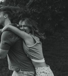 black and white photograph of two people hugging each other