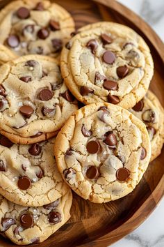 chocolate chip cookies in a wooden bowl on a marble table