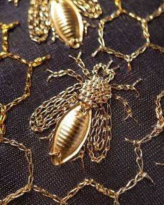 many gold chains and bugs on a black surface