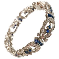 An absolutely stunning Art Deco diamond and sapphire platinum bracelet made by Tiffany & Co. The bracelet contains 136 round diamonds, of F-G color, VS clarity, weighing a total of 4.32cts set in a horse shoe style links. the bracelet also contains 48 square cut and round sapphires, having a total weight of 4.80cts. Signed: Tiffany & Co. Hallmark: IRID PLAT Length: 7.00 inches Tiffany And Co Diamond, Music Note Necklace, Tiffany And Co Bracelet, Bracelet Art, Art Bracelet, Tiffany Diamond, Platinum Bracelet, Art Deco Bracelet, Vintage Tiffany