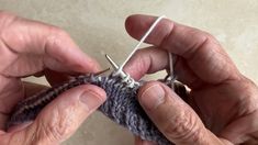 an older person is knitting something with scissors