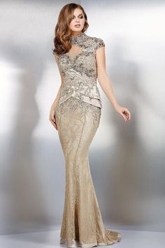 This stunning gown is perfect for any special occasion. Crafted from luxurious lace, embroidered fabric and beaded detailing, this column silhouette will make you look and feel like royalty. The high neckline and cap sleeves beautifully frame the face, while the zipper closure at the back adds a touch of sophistication Motb Dress, Floor Length Lace Dress, Jovani Gown, Evening Dress Collection, Jovani Dresses, Mother Of Bride, Stunning Gowns, Groom Dress, Lace Applique