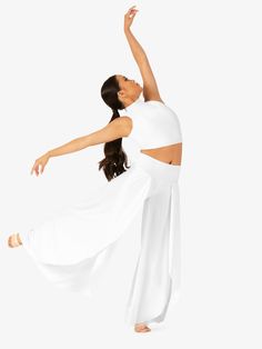 a woman in white is doing a dance move