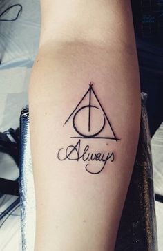 a person with a tattoo on their arm that says alwayss and an image of the deathly symbol