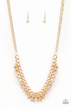 A fringe of glittery rhinestones swings from the bottom of a bold gold chain below the collar for a fierce look. Features an adjustable clasp closure. P2RE-GDXX-274XX Sold as one individual necklace. Includes one pair of matching earrings. Gold Rhinestone Chain Necklace For Party, Rhinestone Chain Link Necklace For Parties, Gold Chain Link Rhinestone Necklace For Party, Party Necklace With Rhinestones And Chain Link, Glamorous Gold Rhinestone Chain Necklace, Glamorous Party Necklace With Gold Chain, Glamorous Gold Rhinestone Necklace With Adjustable Chain, Party Rhinestone Necklace With Gold Chain, Party Crystal Jewelry With Gold Chain