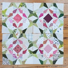 a patchwork quilt on a wooden surface