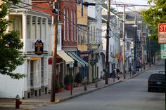 a city street lined with tall buildings and shops