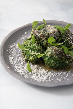 a plate topped with broccoli covered in pesto