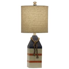 a lamp that is on top of a wooden block with a rope attached to it